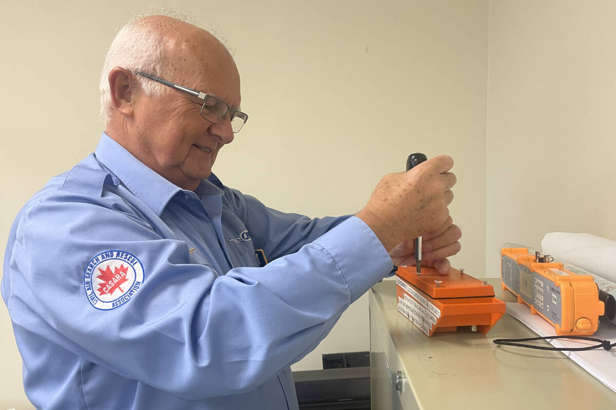 Robert Northcott gets an emergency location transponder ready for Civil Air Search and Rescue Association ground search training in North Saanich. (Christine van Reeuwyk/Peninsula News Review)