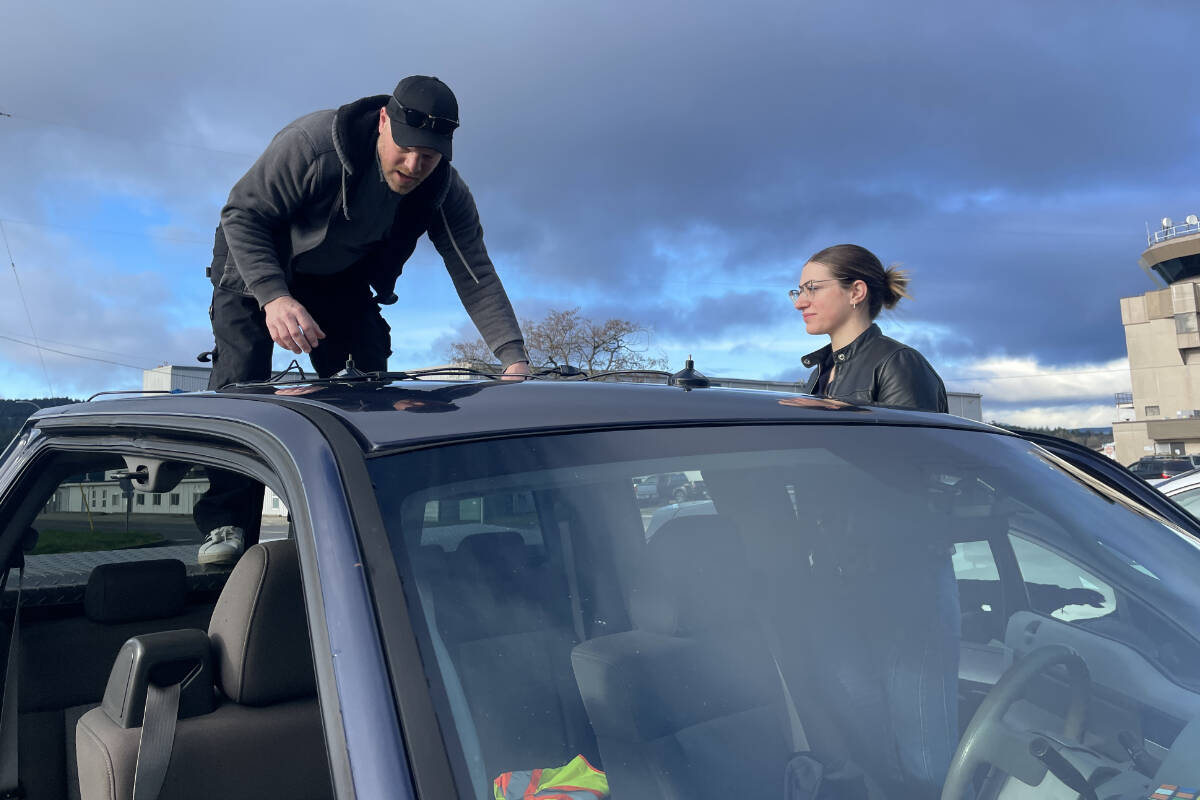 Michael Steenvoorden and Vanessa Waugh prepare for a CASARA ground search exercise with temporary locator equipment attached to volunteer vehicles. (Christine van Reeuwyk/Peninsula News Review)