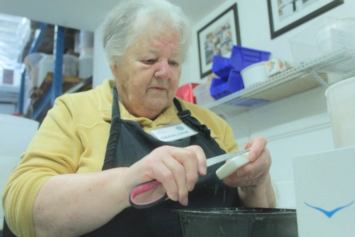 Geraldine revitalizes bar soap with a knife and deft hands in the Soap for Hope warehouse in Vic West. (Christine van Reeuwyk/Victoria News)