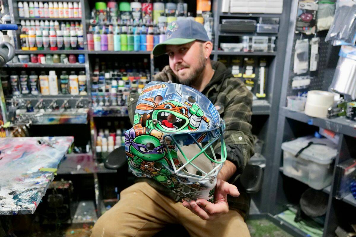 TM Kustoms creator Travis Michael presents a custom Teenage Mutant Ninja Turtles goalie mask from his studio. (Tony Trozzo/Saanich News)