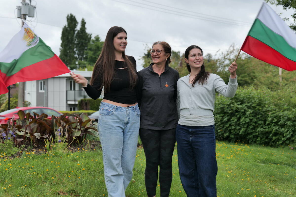 Elizabeth Tzatcheva, Theodora Borissov and Stephanie Borissov wave the Bulgaria flag with pride to celebrate the country’s Eurovision Song Contest win. (Ben Fenlon/Saanich News)